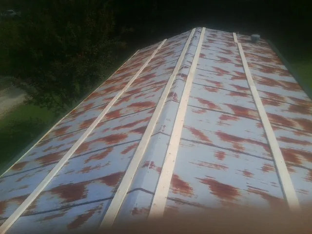 Rusted metal roof panels with new wood purlins before replacement — Storm Damage Roof Repair in Tampa by Roofing Brothers